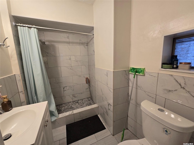 bathroom featuring toilet, vanity, tile walls, and curtained shower