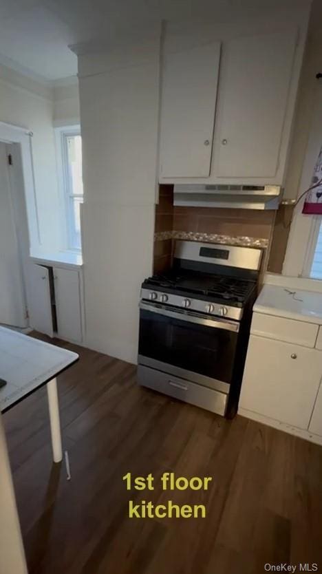 kitchen featuring stainless steel range with gas cooktop, white cabinetry, and dark wood-type flooring