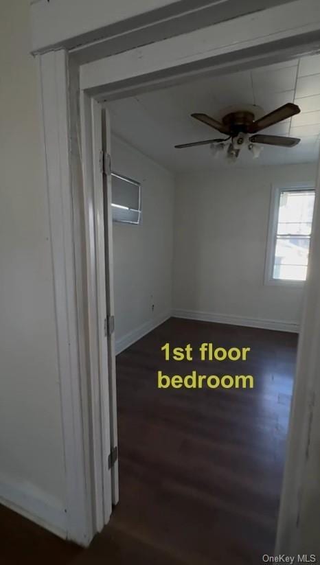 spare room with ceiling fan and dark hardwood / wood-style floors