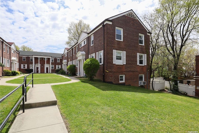 view of home's exterior featuring cooling unit and a lawn