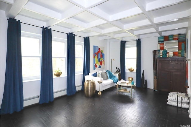 sitting room featuring beamed ceiling, a baseboard radiator, a healthy amount of sunlight, and coffered ceiling