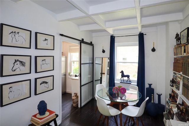 dining area featuring beam ceiling, a barn door, dark wood-type flooring, and coffered ceiling