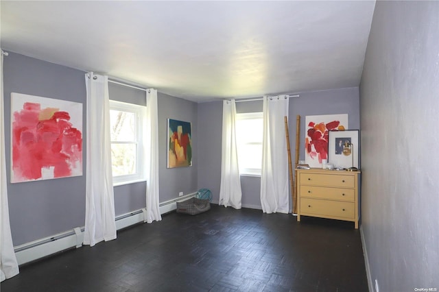 unfurnished bedroom featuring a baseboard heating unit