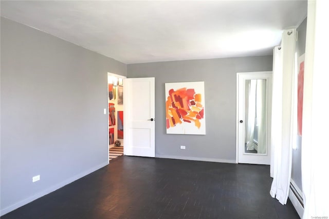 unfurnished room featuring dark hardwood / wood-style floors and a baseboard radiator