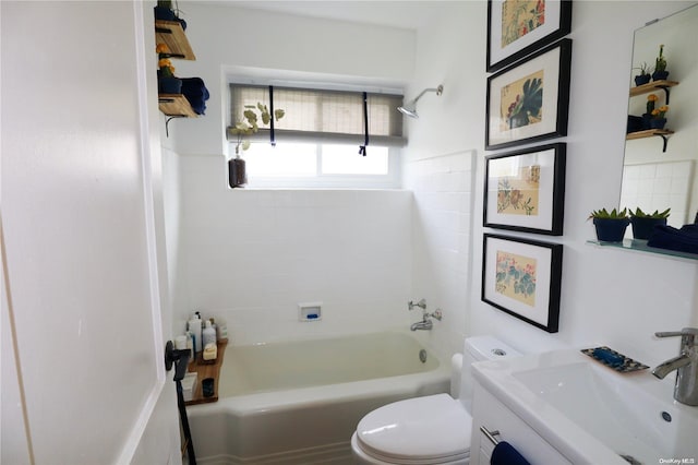 full bathroom featuring vanity, tiled shower / bath combo, and toilet