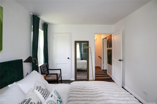 bedroom with dark wood-type flooring