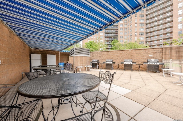 view of patio / terrace featuring an outdoor kitchen and a grill