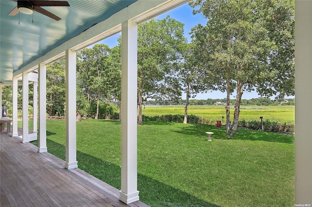 view of yard with covered porch and ceiling fan