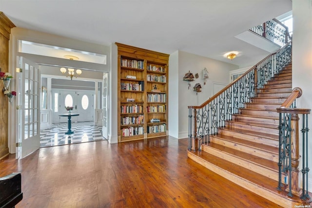 entrance foyer with a notable chandelier and wood-type flooring