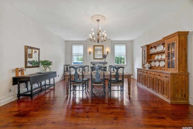 dining space with a chandelier and dark hardwood / wood-style flooring