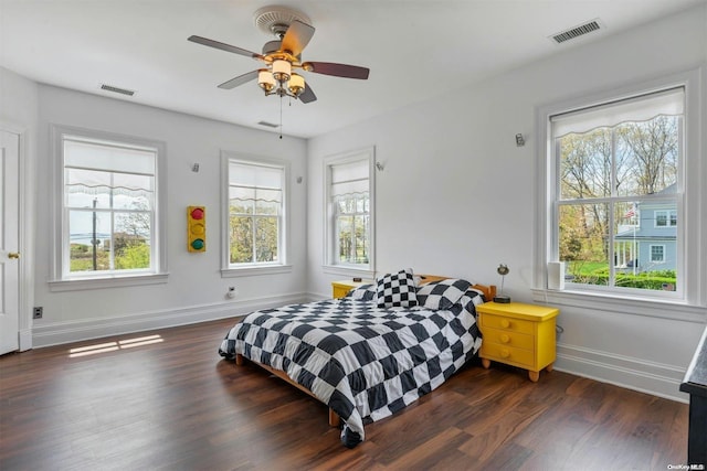 bedroom with ceiling fan and dark hardwood / wood-style floors