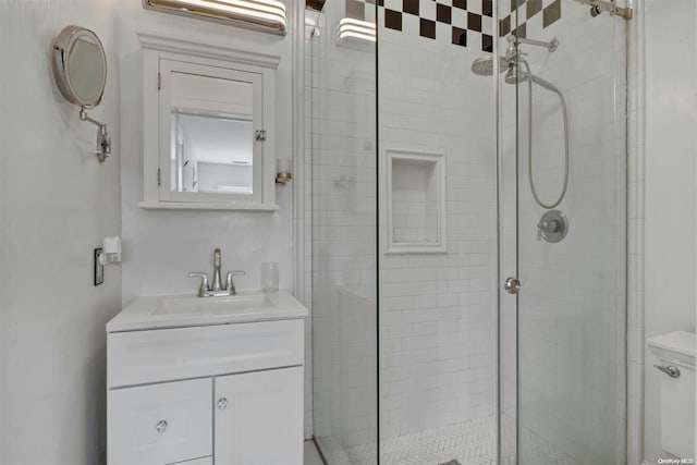 bathroom featuring vanity and a shower with shower door