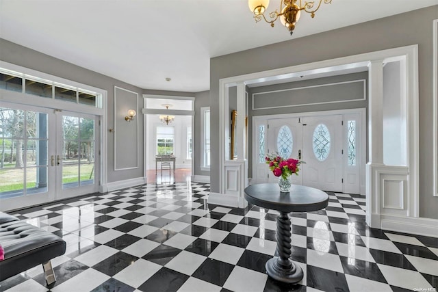 entryway featuring a notable chandelier, plenty of natural light, and french doors