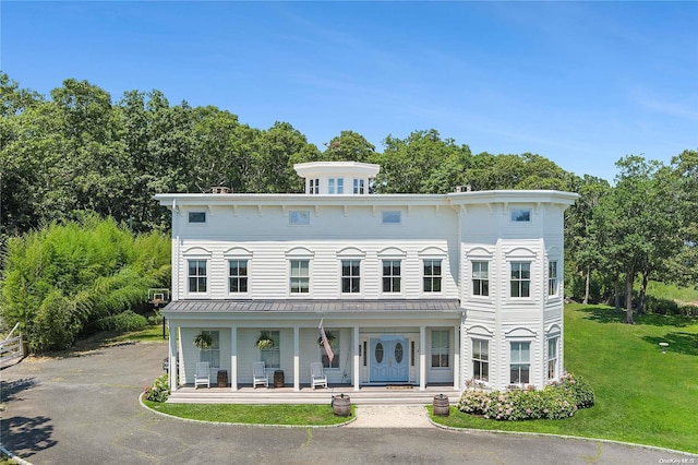 italianate house with a porch and a front yard