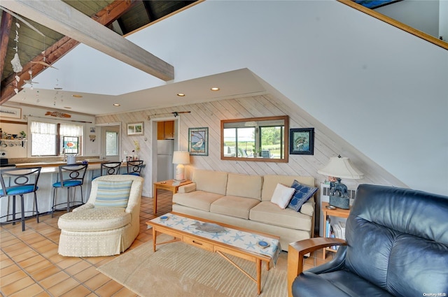 living room with light tile patterned floors and lofted ceiling with beams