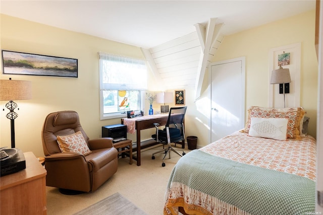 bedroom with light colored carpet and vaulted ceiling