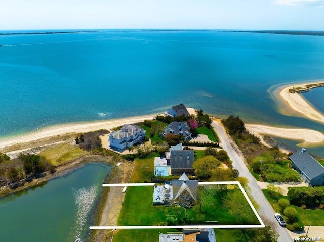 drone / aerial view featuring a water view and a view of the beach