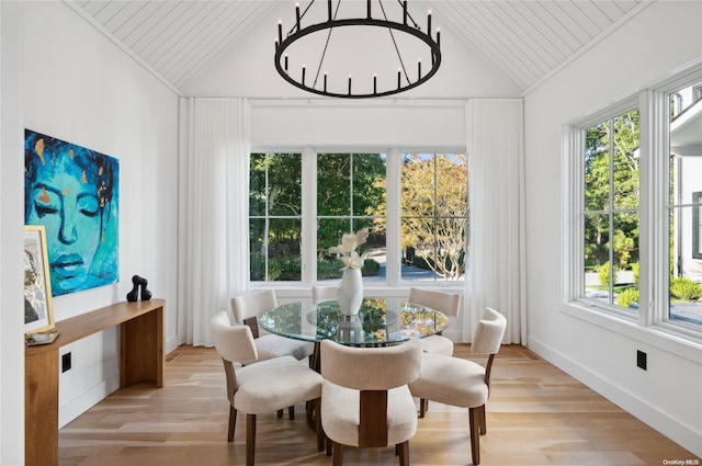 dining space with plenty of natural light, light wood-type flooring, and vaulted ceiling