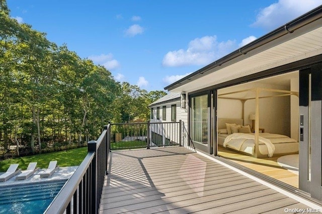 wooden terrace featuring a swimming pool