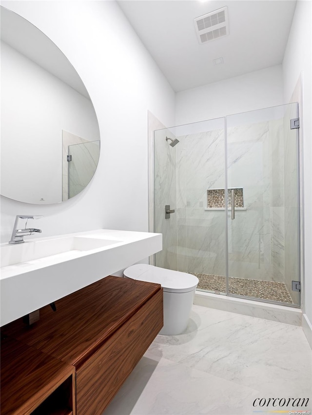 bathroom with vanity, toilet, and a shower with shower door