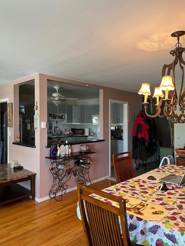 dining area featuring light hardwood / wood-style floors and ceiling fan