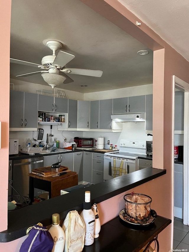 kitchen with stainless steel refrigerator, gray cabinetry, electric range, ceiling fan, and light tile patterned floors