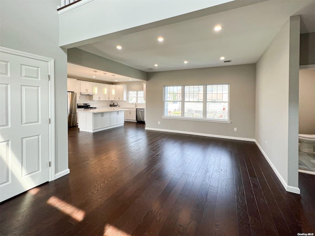 unfurnished living room featuring dark hardwood / wood-style flooring