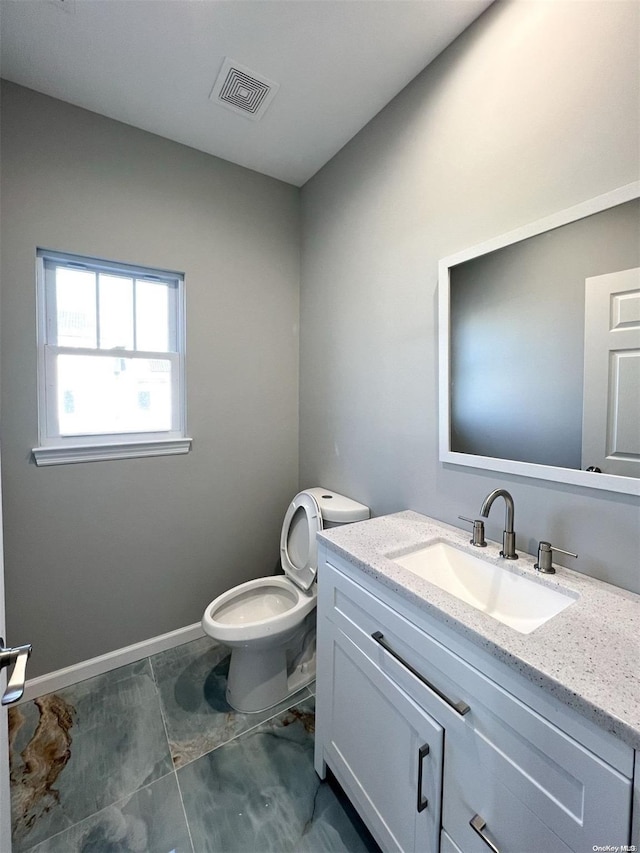 bathroom featuring vanity and toilet