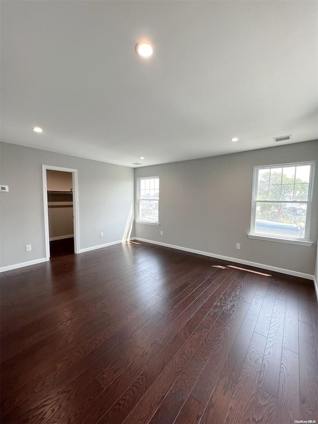 spare room with dark wood-type flooring