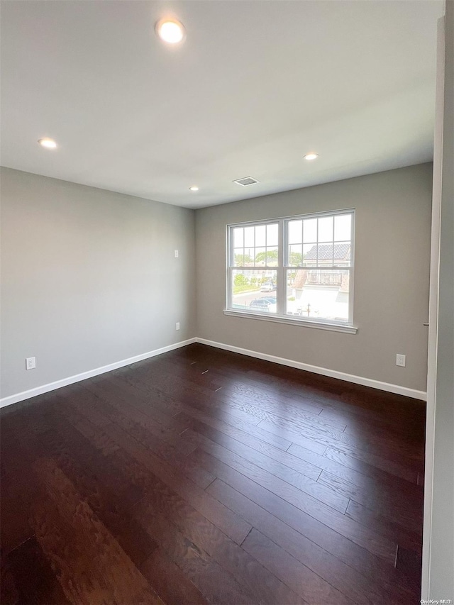 spare room with dark wood-type flooring