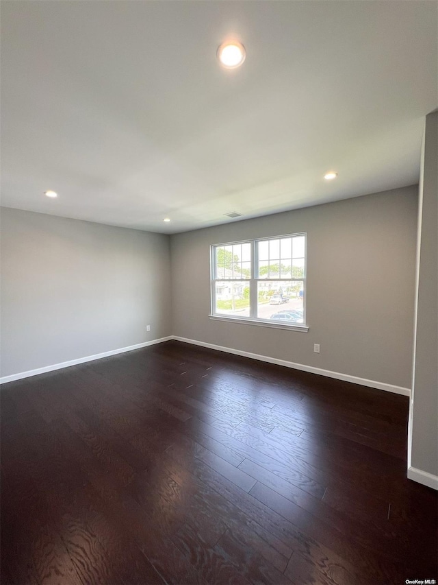 spare room featuring dark hardwood / wood-style flooring