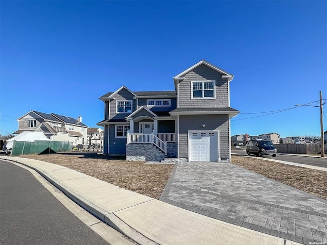 view of front of home with a porch and a garage