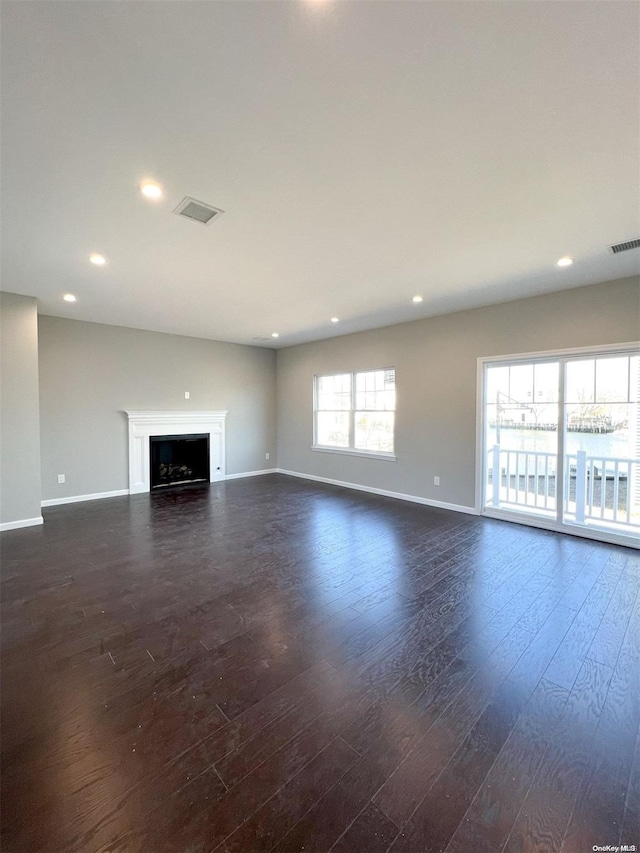 unfurnished living room with dark hardwood / wood-style flooring