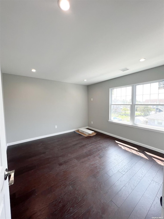 spare room with dark hardwood / wood-style floors