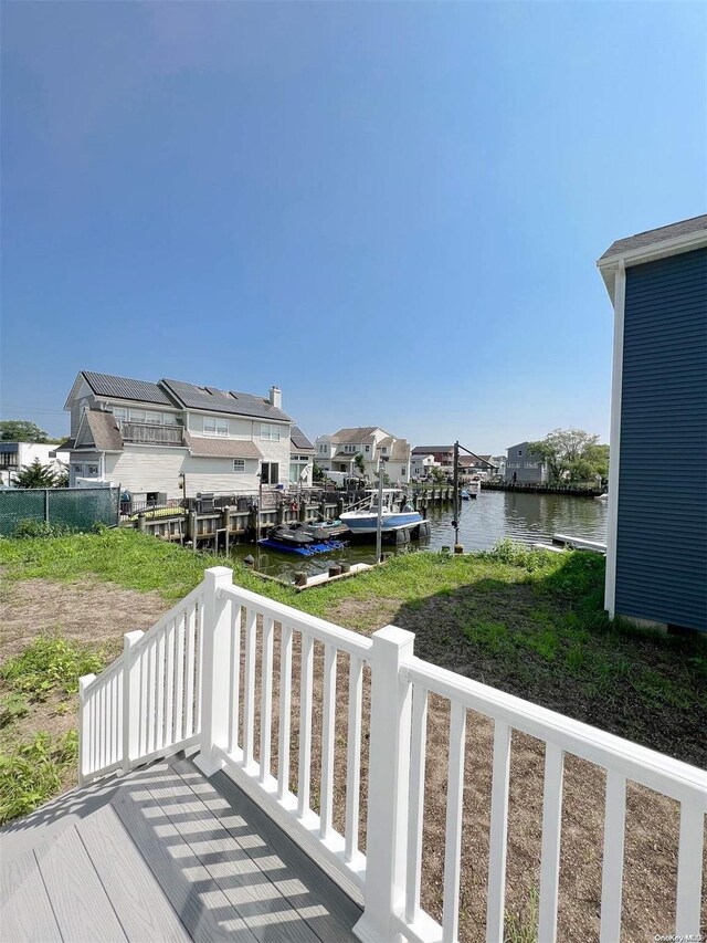 wooden deck featuring a dock and a water view