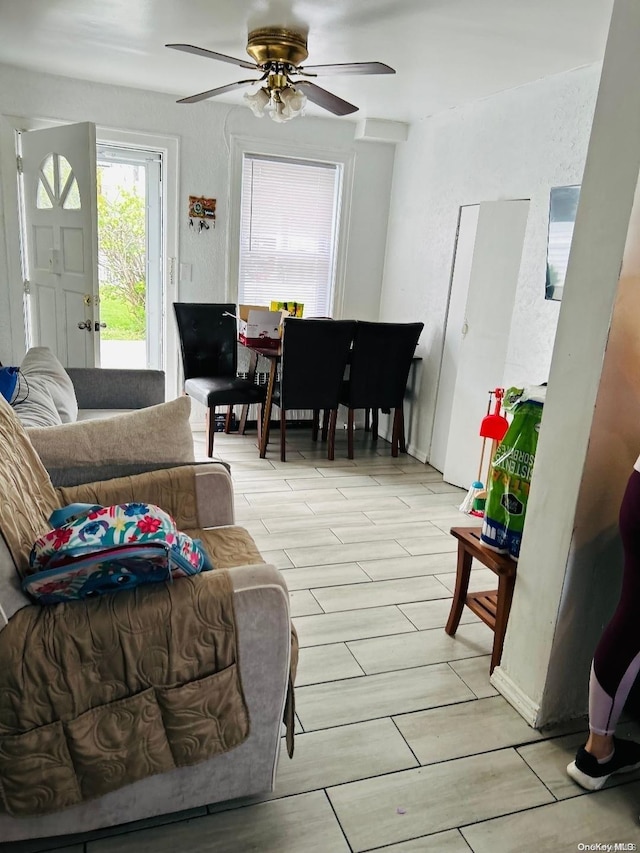 living room featuring ceiling fan and light wood-type flooring