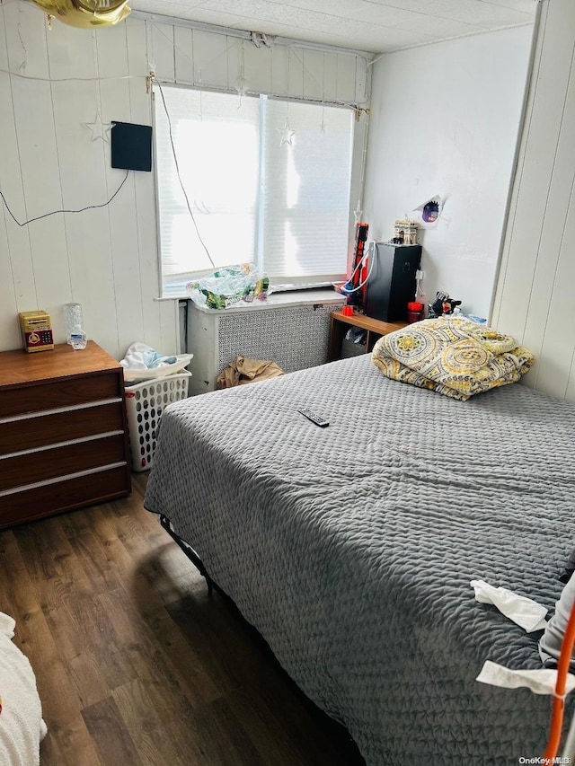 bedroom with dark hardwood / wood-style floors