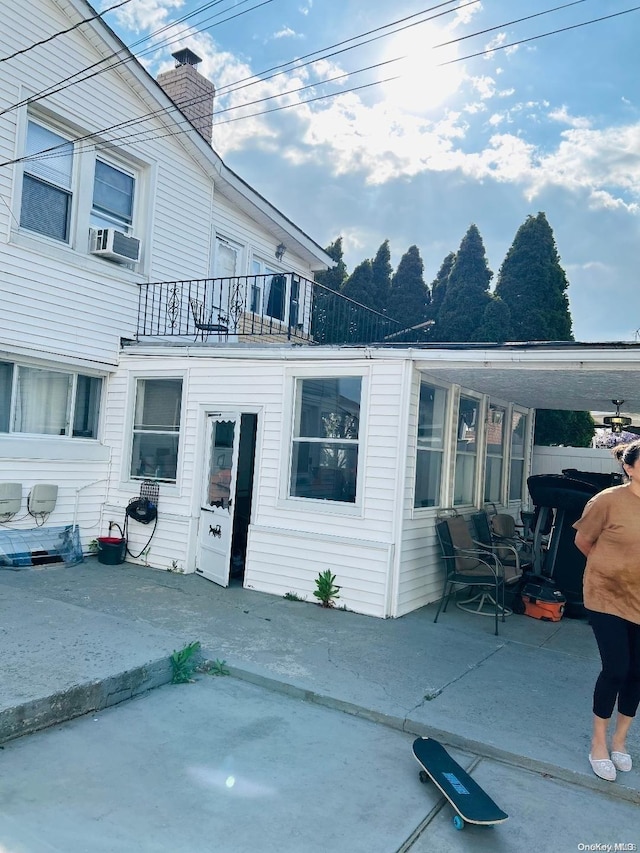 back of house featuring a patio, a balcony, and cooling unit