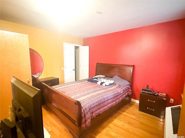 bedroom with light hardwood / wood-style floors