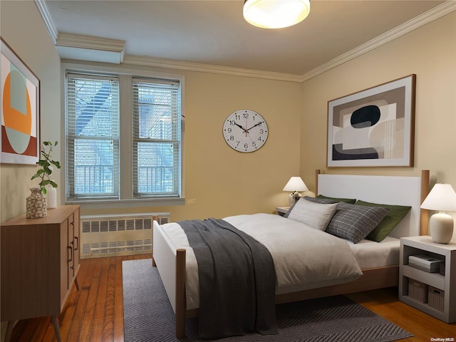 bedroom featuring hardwood / wood-style flooring, crown molding, and radiator