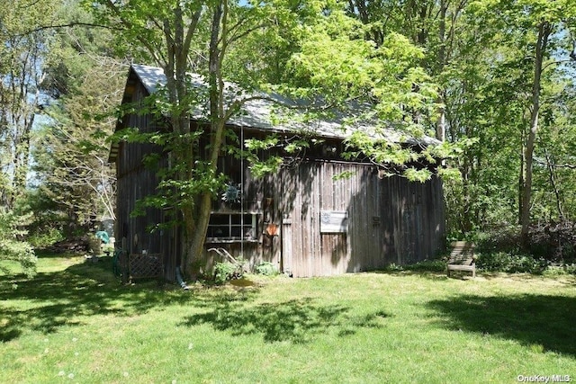 view of outbuilding featuring a lawn