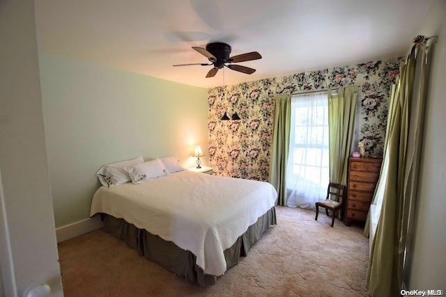 bedroom featuring ceiling fan and light carpet