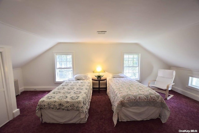 carpeted bedroom featuring multiple windows, lofted ceiling, and radiator