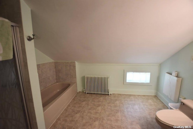 bathroom with lofted ceiling, toilet, radiator heating unit, and a washtub