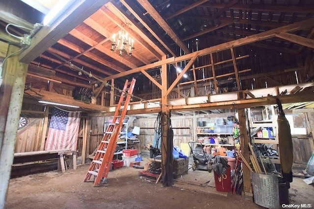 misc room with lofted ceiling and a chandelier