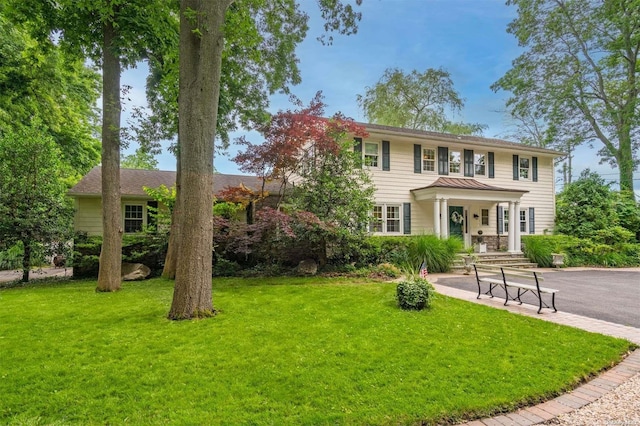 colonial inspired home featuring a front lawn