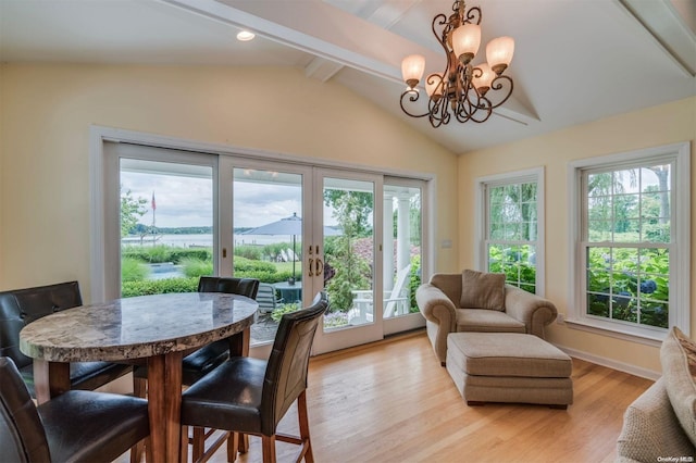 interior space featuring a chandelier, vaulted ceiling with beams, and a healthy amount of sunlight