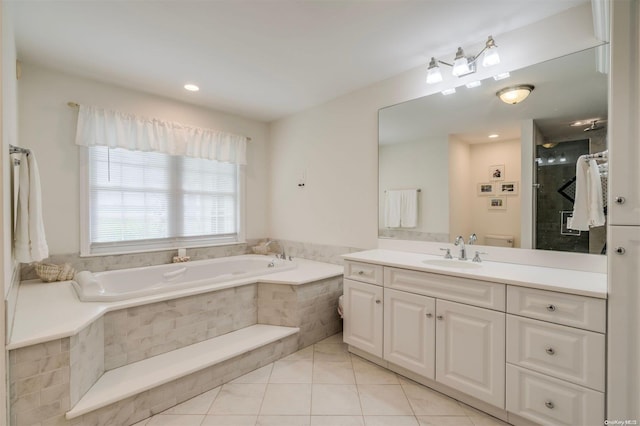 bathroom with tile patterned floors, vanity, and independent shower and bath