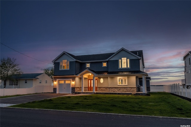 view of front of home featuring a lawn and a garage