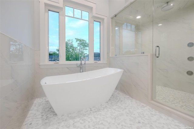 bathroom featuring plenty of natural light and plus walk in shower